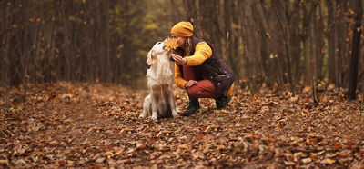 Woman and Dog sitting in leaves